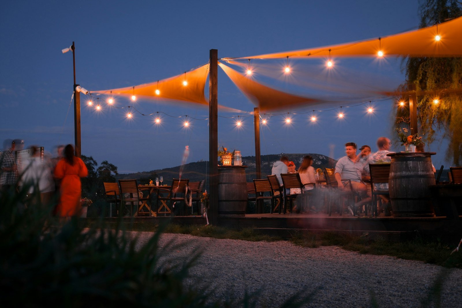 Outdoor restaurant patio with string lights at dusk